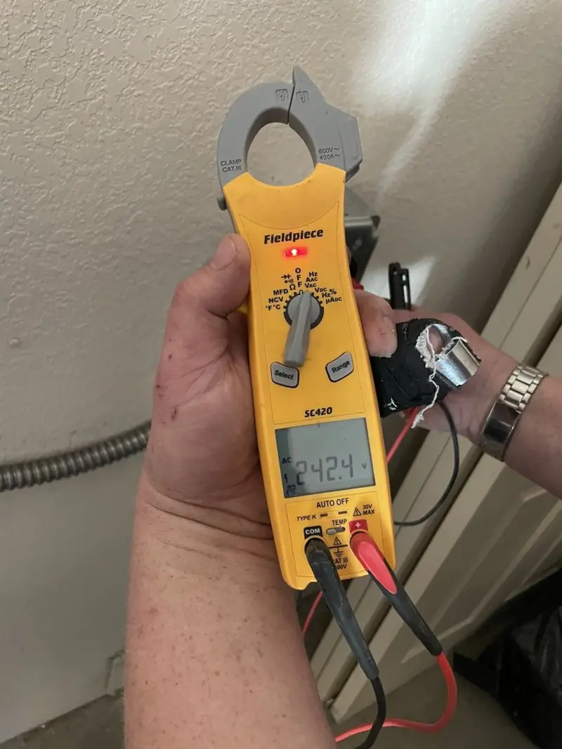Voltage testing with clamp meter during Ceiling Fan Installation in Hutto